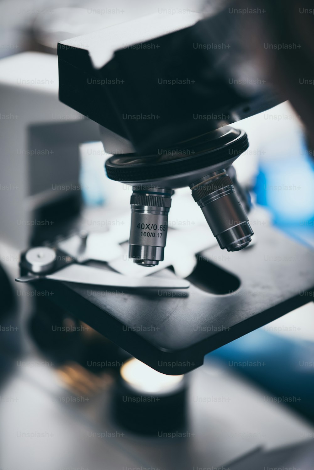 Close-up shot of microscope with metal lens at laboratory.