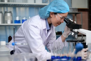 In a Modern Laboratory Research Scientist Conducts Experiments by Synthesising Compounds