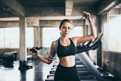 Close up Asian sport girl in sportwear exercising in fitness club. Attractive  athlete young female stand showing abs after finished worked out with  machines and equipment in gym stadium or fitness. photo –