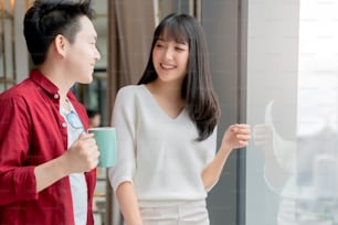 Happiness asian couple laugh smile together with in kitchen pantry humor emotional casual relax with room interior background
