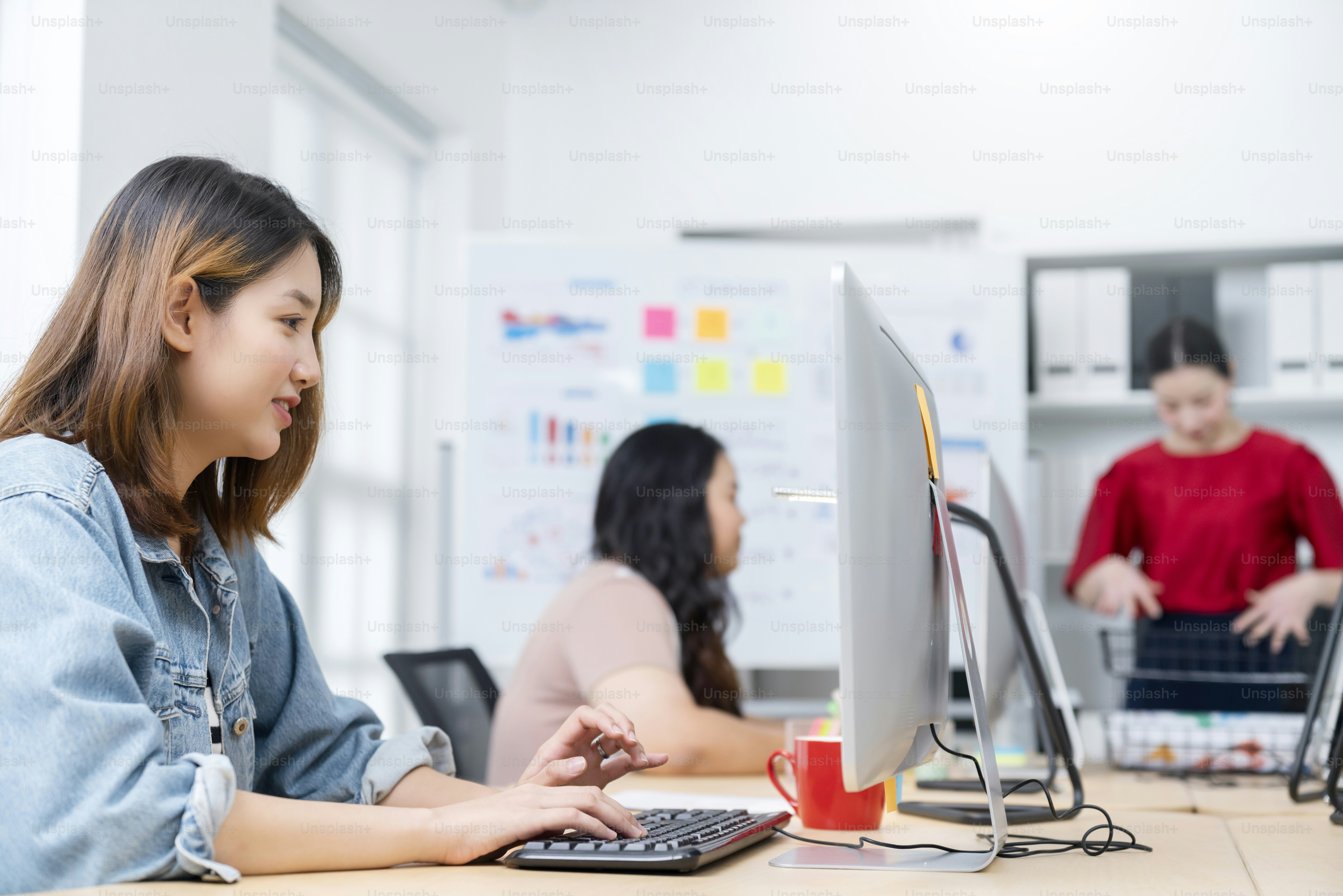 Casual creative office brainstorm. Group of young creative smart people working and communicating while sitting at the office desk together with colleagues sitting discuss together