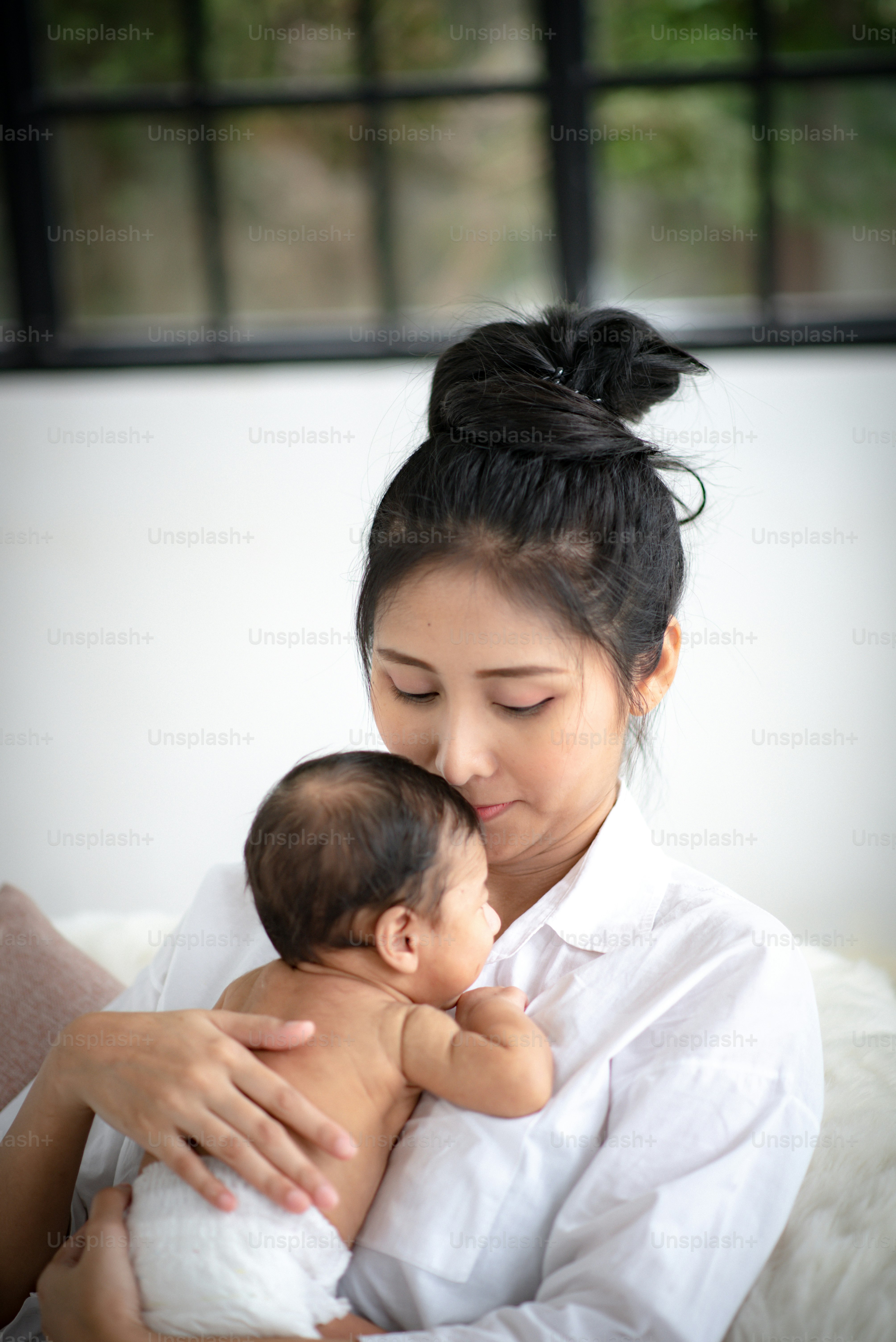 Mother is hugging and showing love to baby