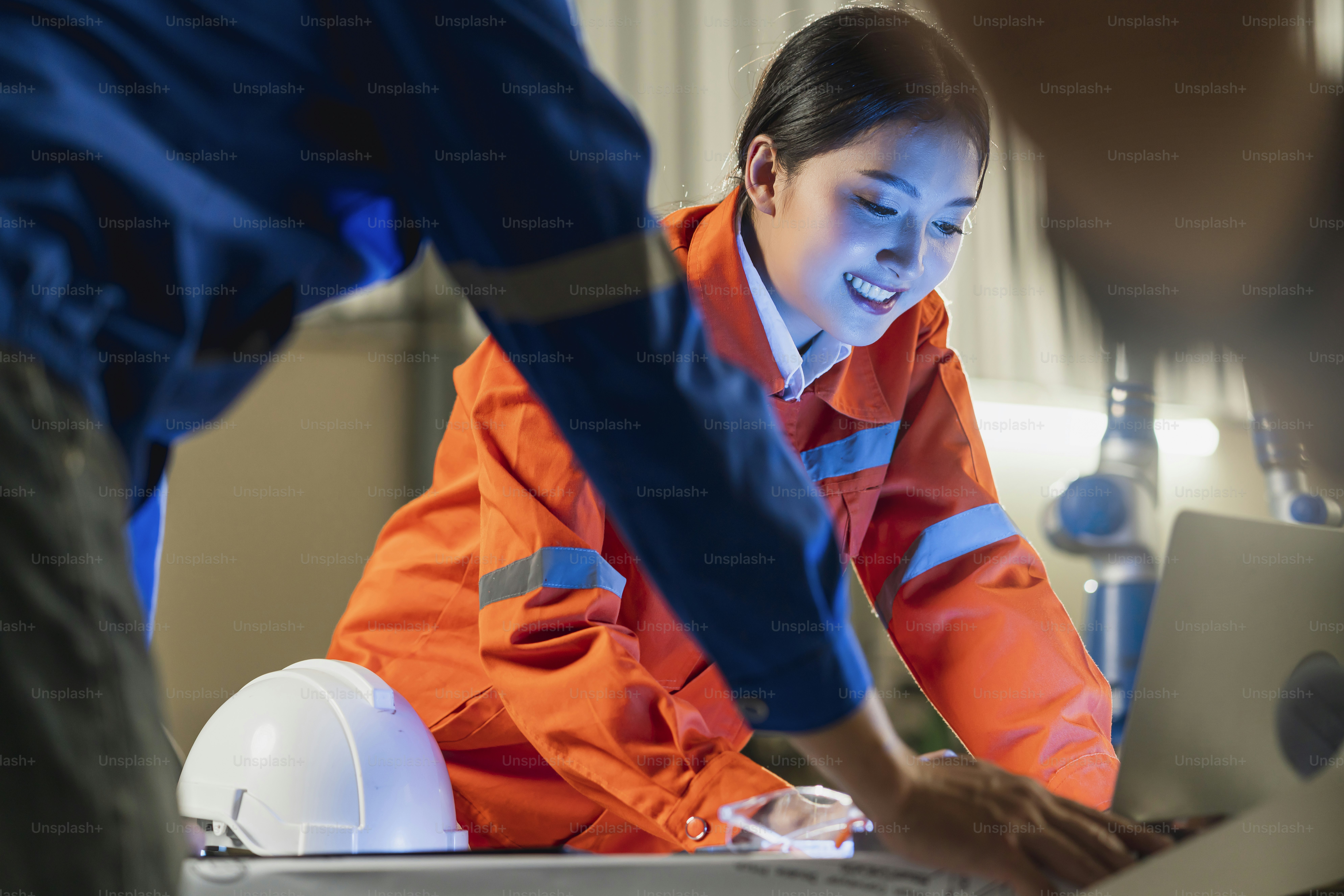 engineer cooperation Two asian male and female technician maintenance inspect relay robot system with tablet laptop to control quality operate process work heavy industry 4.0 manufacturing factory