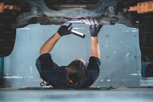 mechanic car service working in garage, workshop to check and maintenance repair automobile, suspension industry technology, vehicle inspection fix man technician work