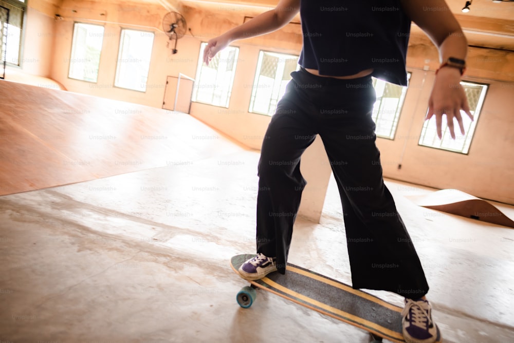 young woman person in sport skate lifestyle, happy teen girl having fun with skateboard in sport gym, hipster fashion urban activity trendy