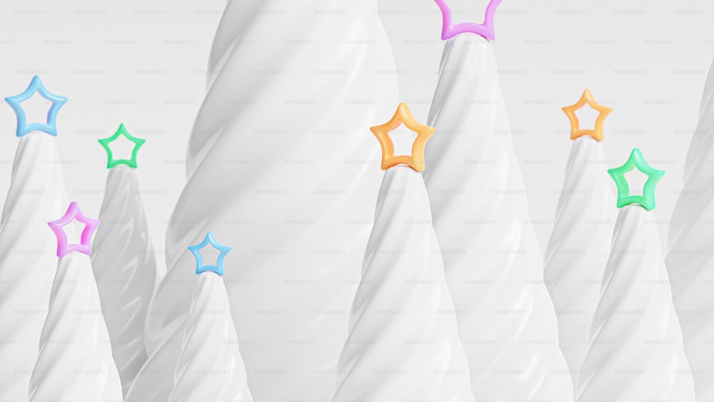 a row of white vases with different colored stars on them