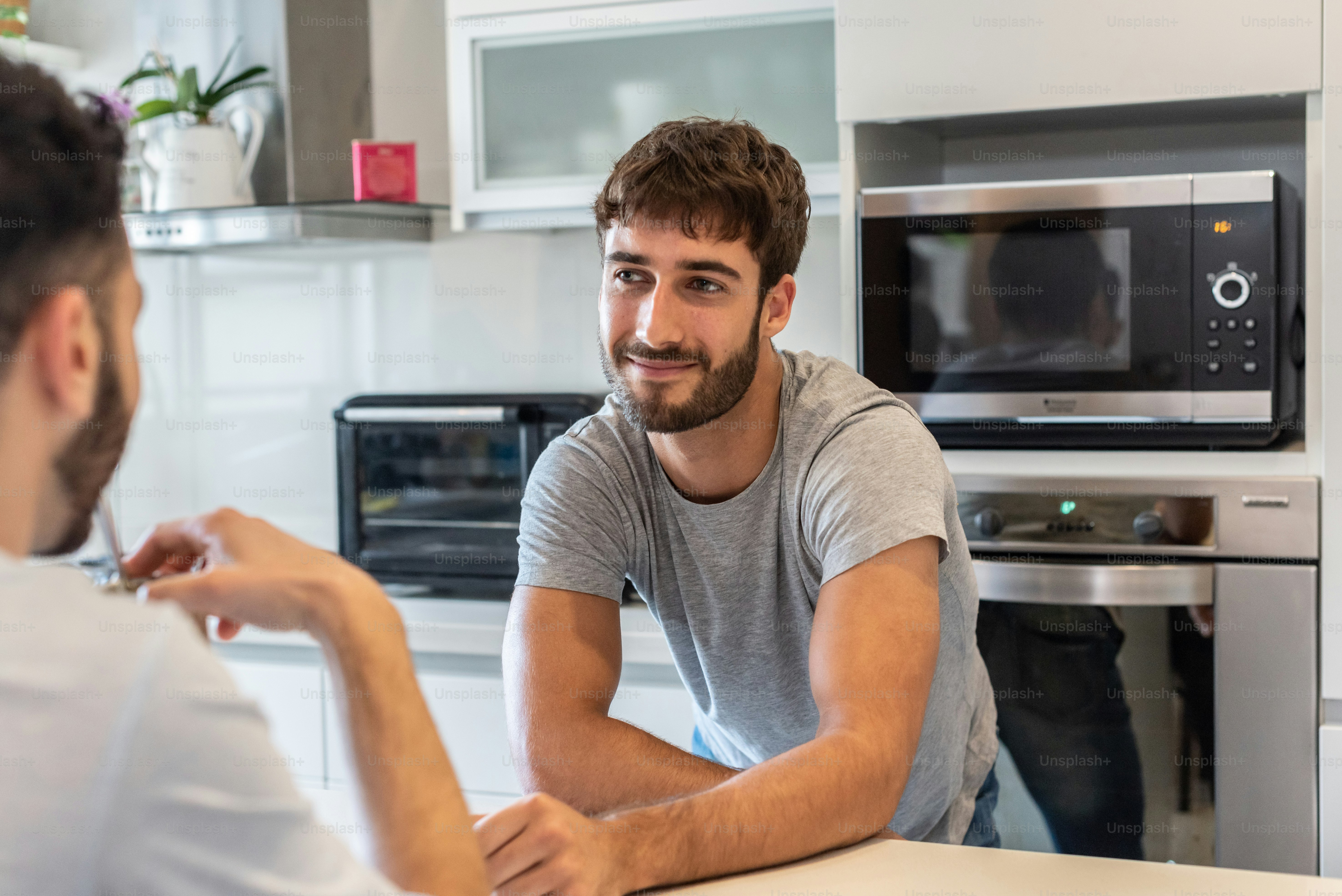 Young couple talking in the kitchen