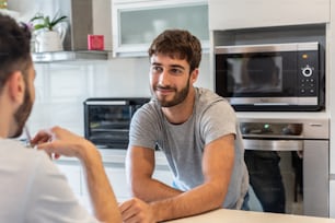Young couple talking in the kitchen