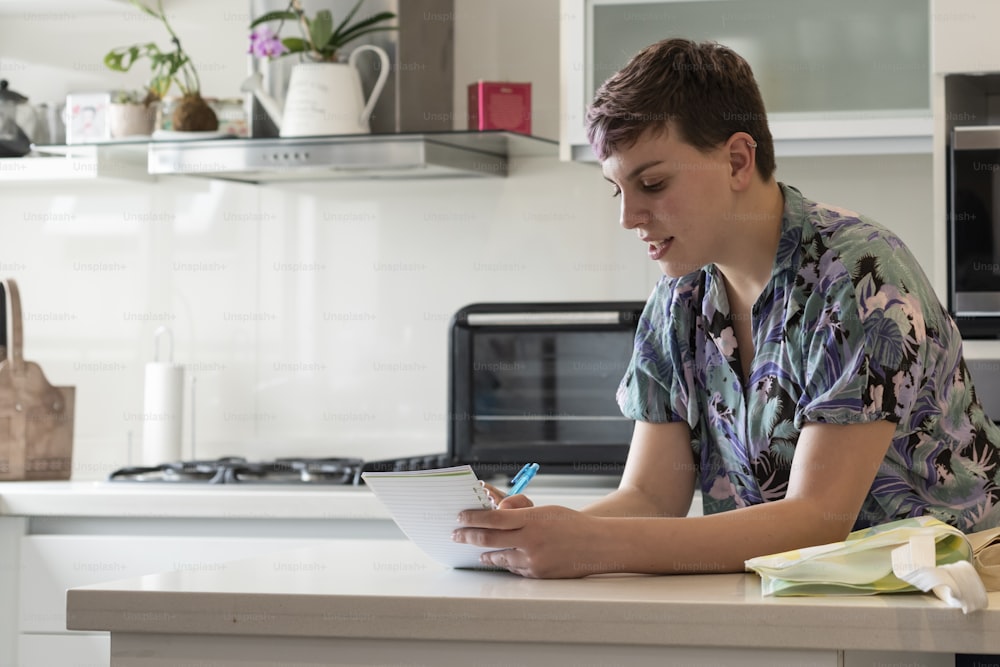 Woman writing list to go to supermarket