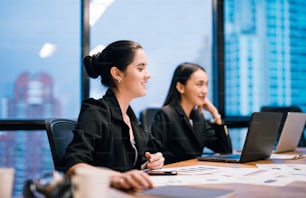 Young business woman working on laptop in the office