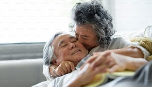 Celebrating wedding Anniversary, Asian Senior couple in love. Happy Grandmother kissing on cheek Grandfather.