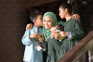 Muslim family, children received money packet as blessing, Hari Raya Eid Al-Fitr concept.