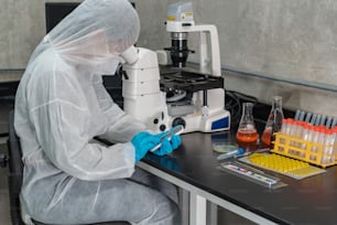 A young scientist sends a text message on her cell phone at a research center.