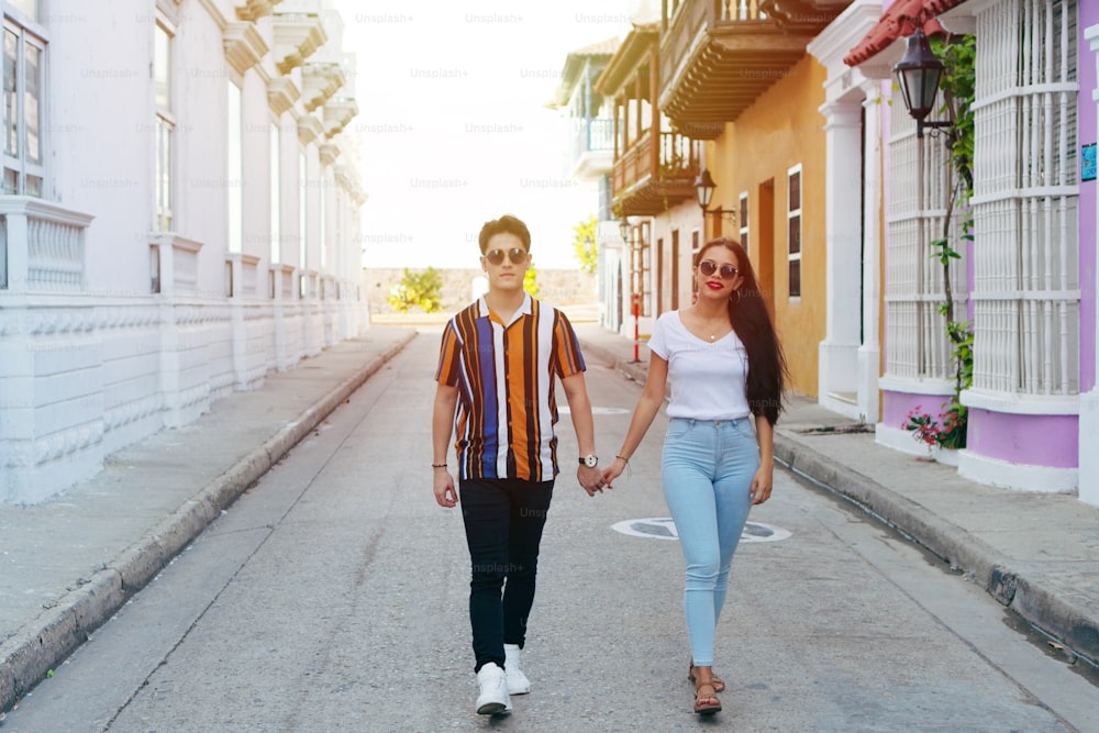 A couple walking down the street in the city