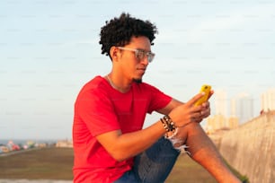 Curly-haired man checked his cell phone outdoors
