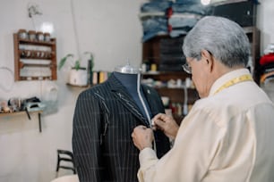 mature Mexican tailor working on local business