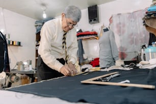 experienced mexican tailor making strokes on fabric