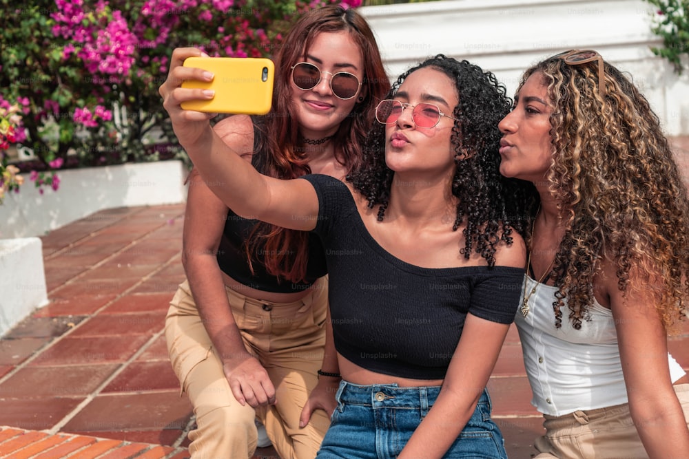 Three young friends making a selfie outdoors