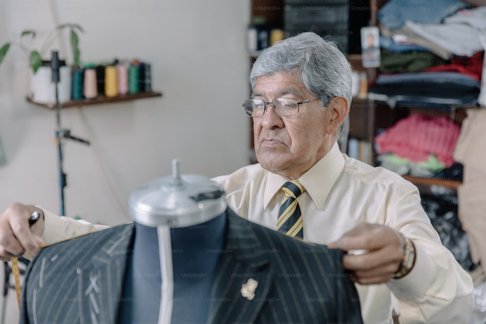Mexican tailor taking measurements in his workshop