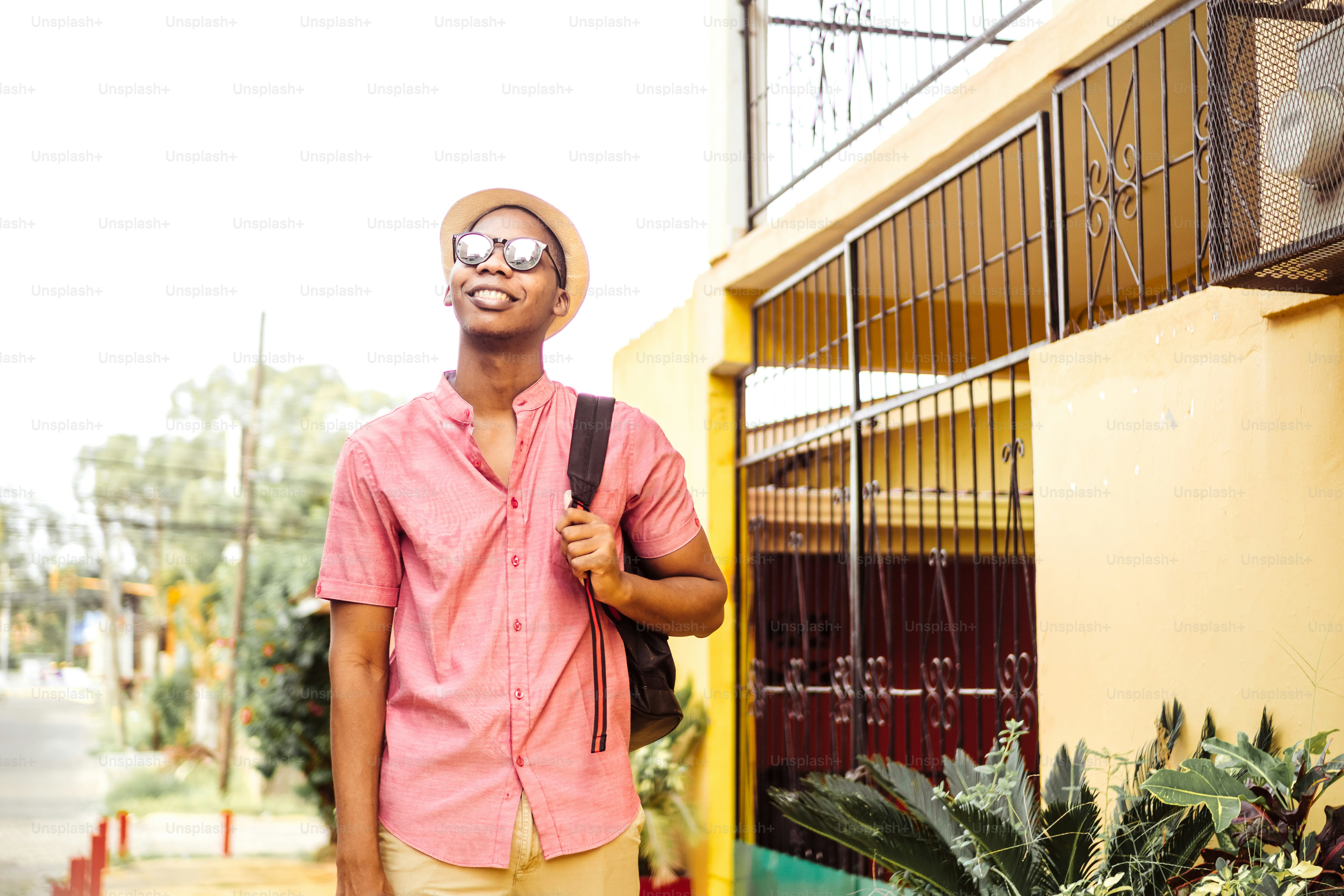 black young adult tourist go with eyeglasses holding a backpack
