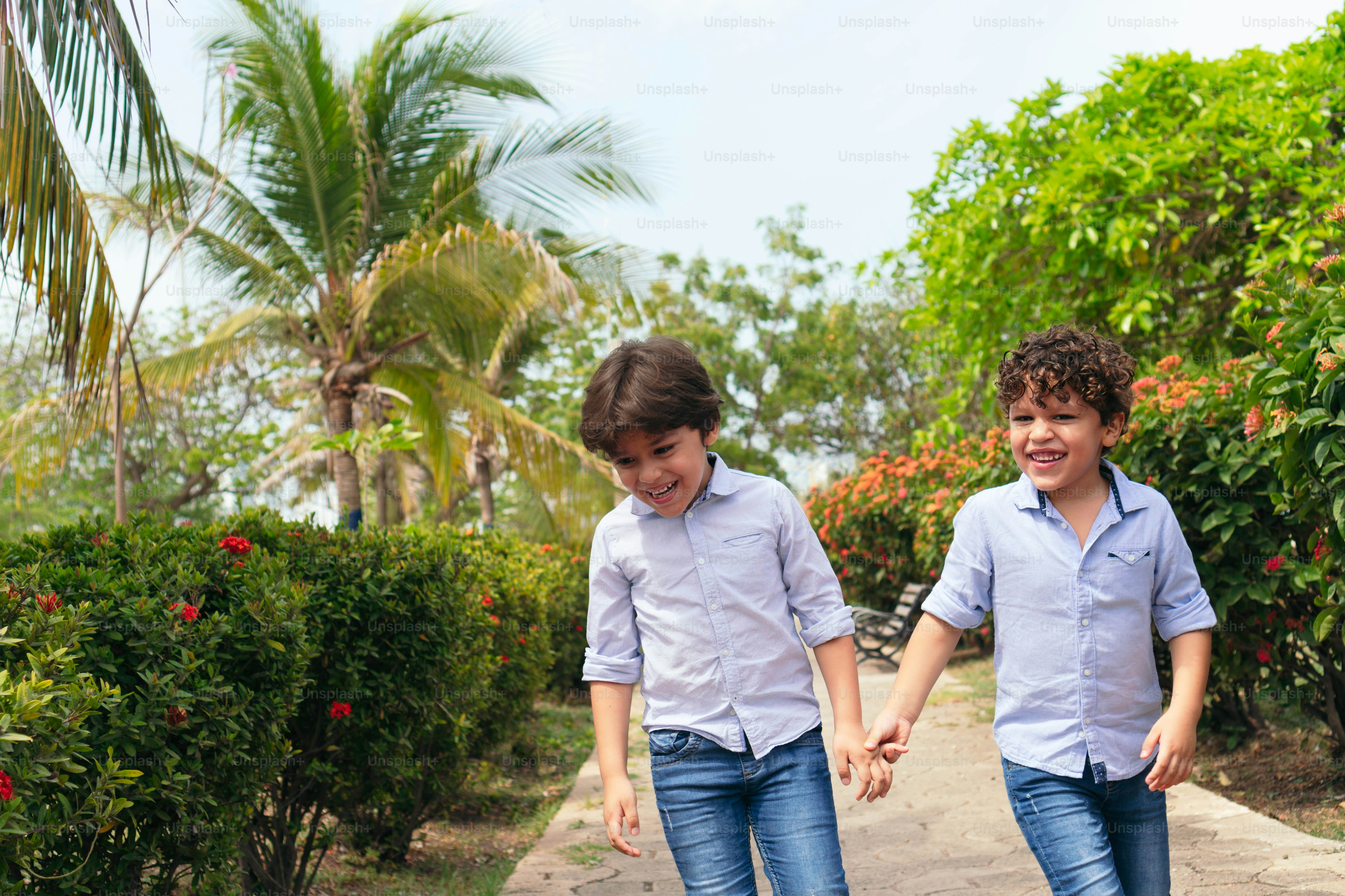 Two little brothers having fun in the park photo – Love - emotion Image ...