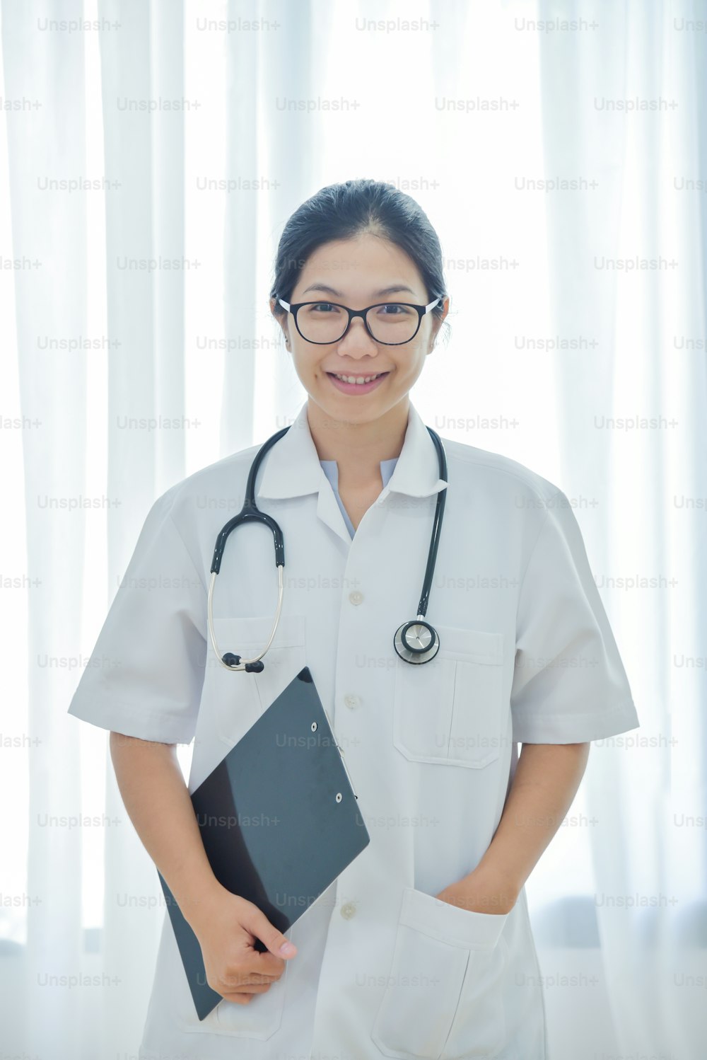 Portrait of a beautiful Asian Female Doctor smiling. copy space.