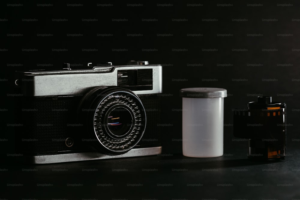 a camera and a container sitting on a table