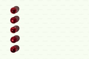 uma fileira de bolas vermelhas em um fundo branco