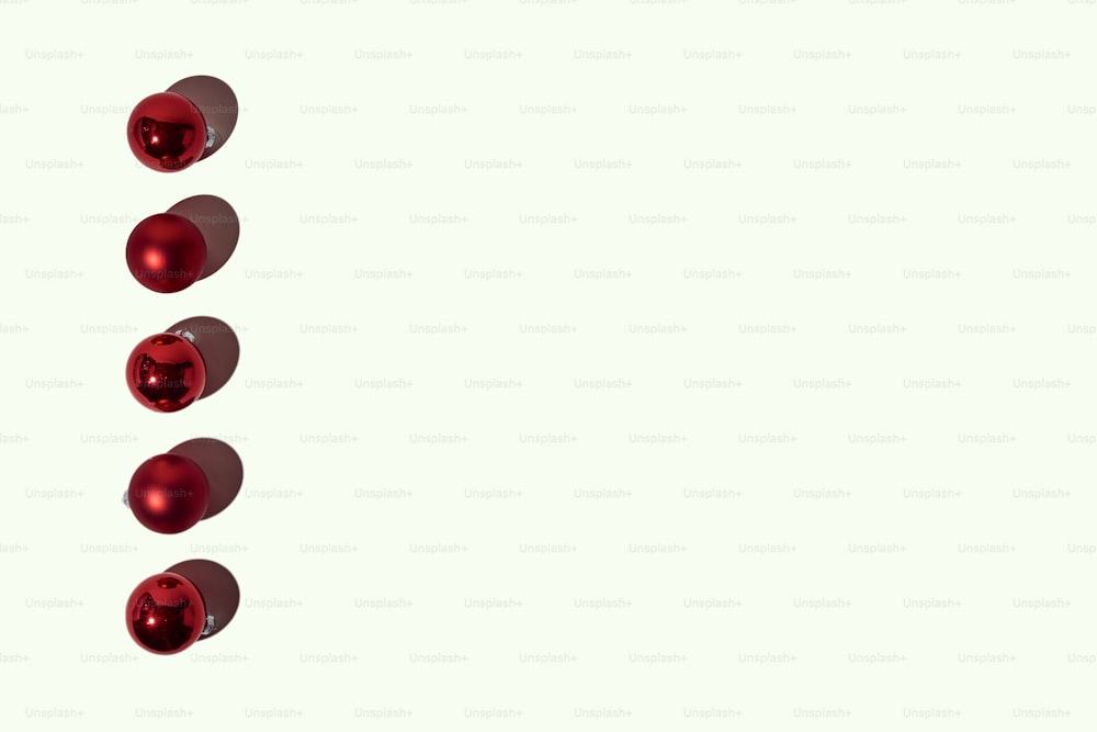 a row of red balls on a white background