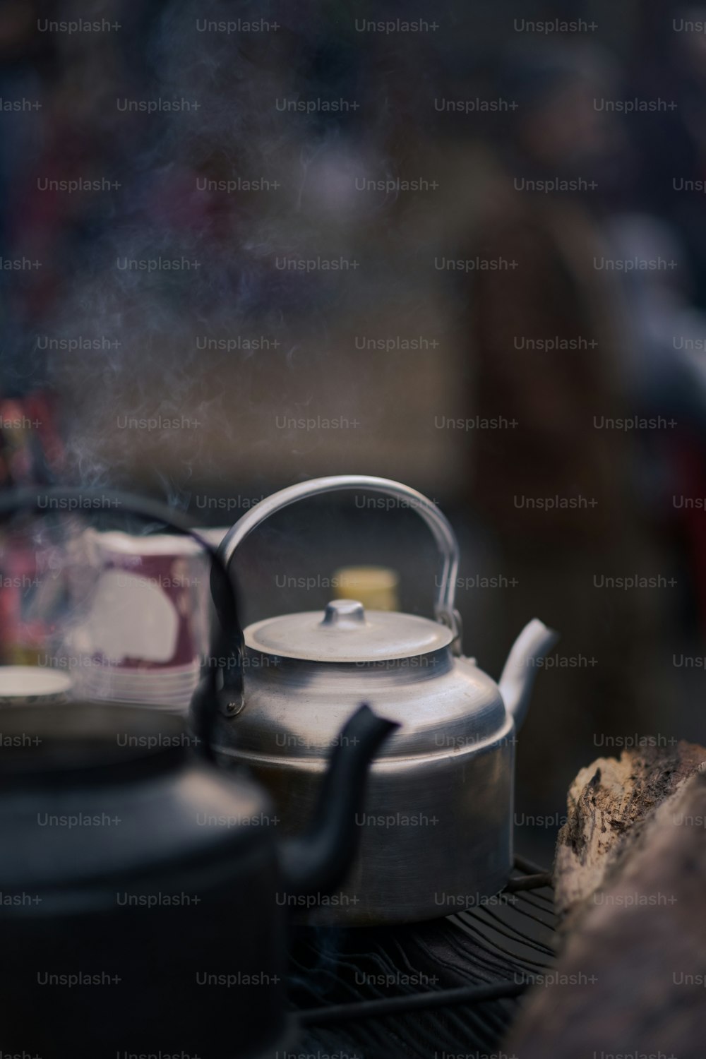 a tea kettle sitting on top of a grill