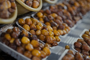 a display of olives and nuts in plastic trays