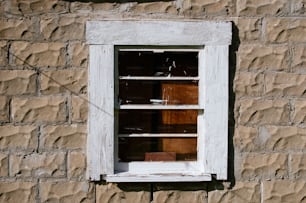 a window with a wooden frame on a brick wall