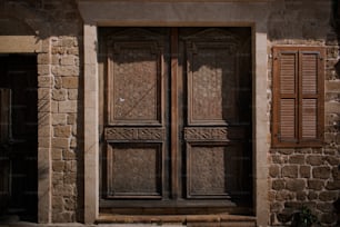 a large wooden door sitting next to a stone building