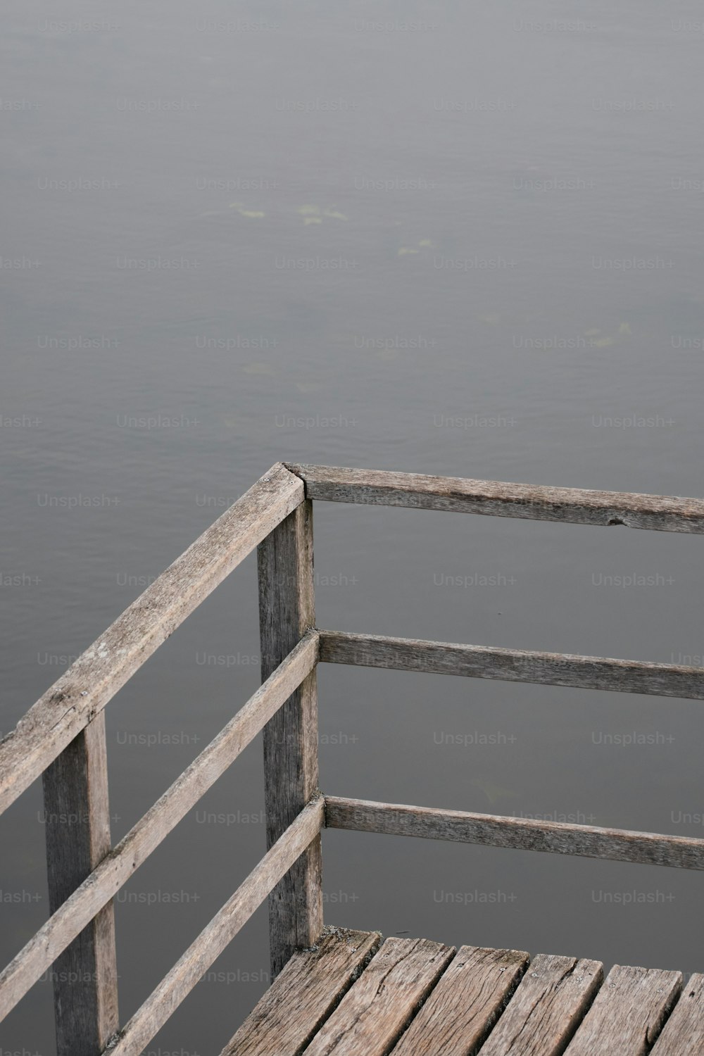 a wooden bench sitting next to a body of water