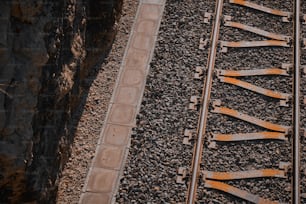 a close up of a train track near a cliff