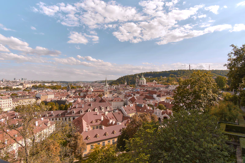 Outdoor seating area at Strahov Monastery Brewery in Prague with the monastery towers and city rooftops behind