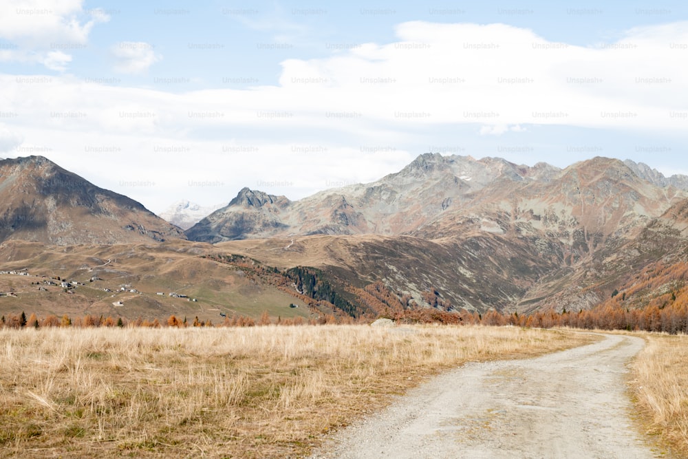 a dirt road in the middle of a mountain range