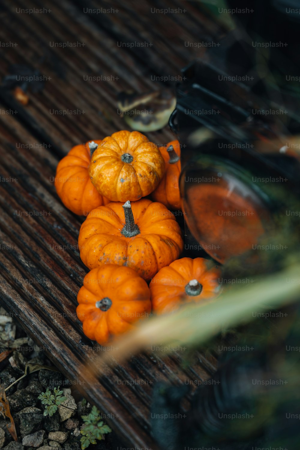 a pile of pumpkins sitting on top of a wooden table