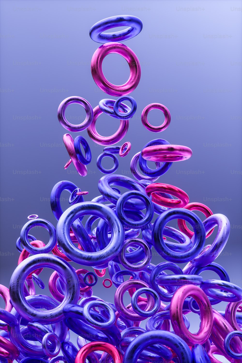 a pile of purple and red rings floating in the air