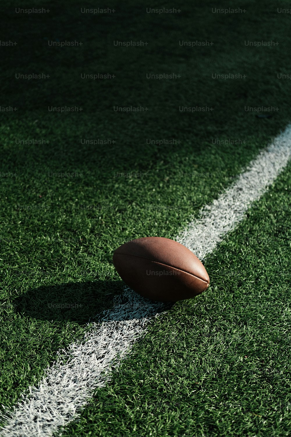 a football sitting on the side of a field