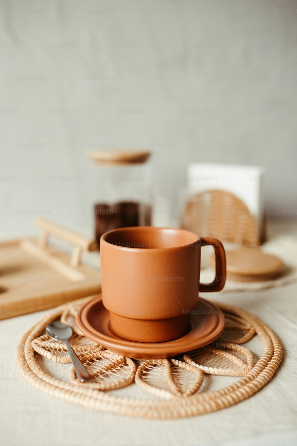 a cup and saucer sitting on a place mat