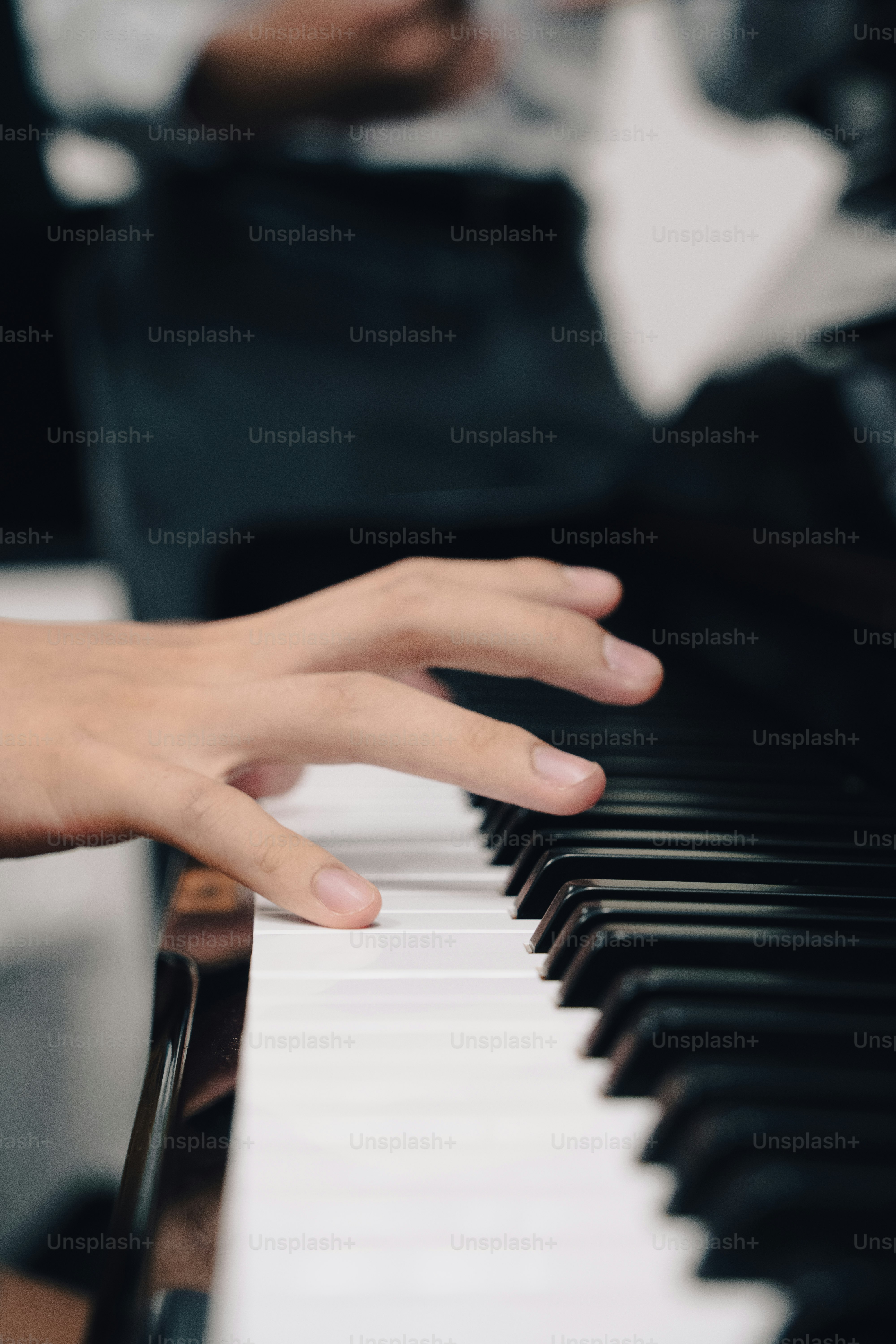 a close up of a person playing a piano