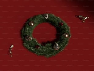 a christmas wreath with ornaments on a red background