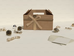 Una caja marrón con una cinta rodeada de decoraciones navideñas