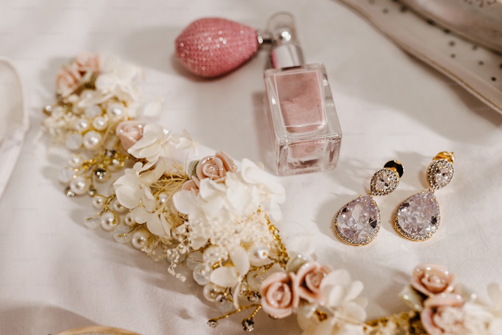 a table topped with jewelry and a bottle of perfume