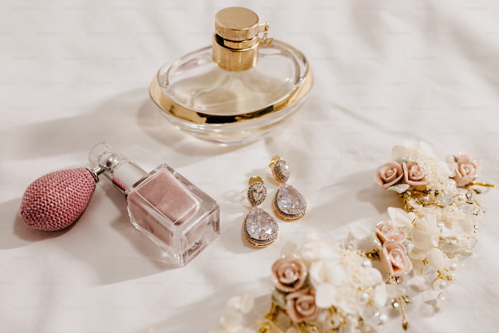 a bottle of perfume next to a bunch of flowers