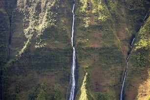 an aerial view of a waterfall in the mountains