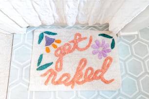 a bathroom rug with the words get out of bed written on it