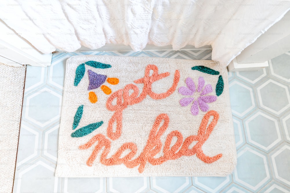 a bathroom rug with the words get out of bed written on it