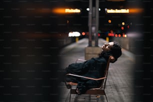 a man laying on a chair on a sidewalk